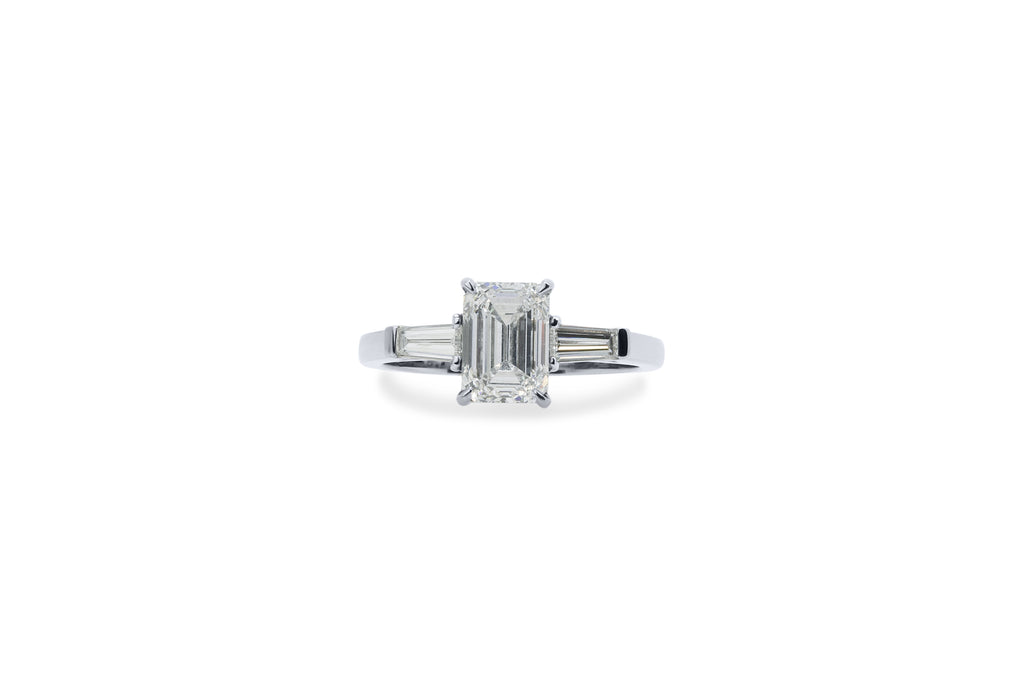 An emerald shaped diamond engagement ring with tapered baguette  shoulders