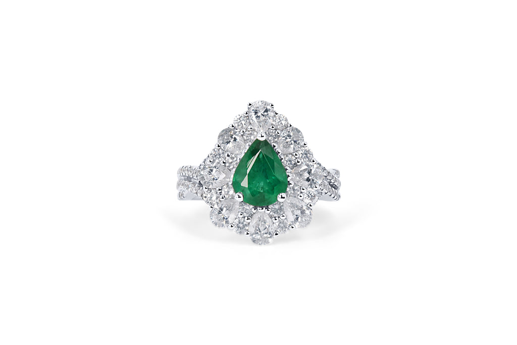 A custom made halo diamond and emerald engagement ring with pear shaped emerald at the centre and diamonds around