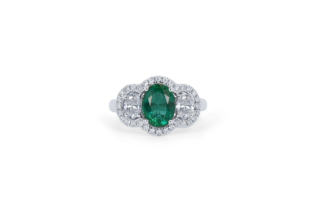 bespoke oval emerald and diamond halo engagement ring 