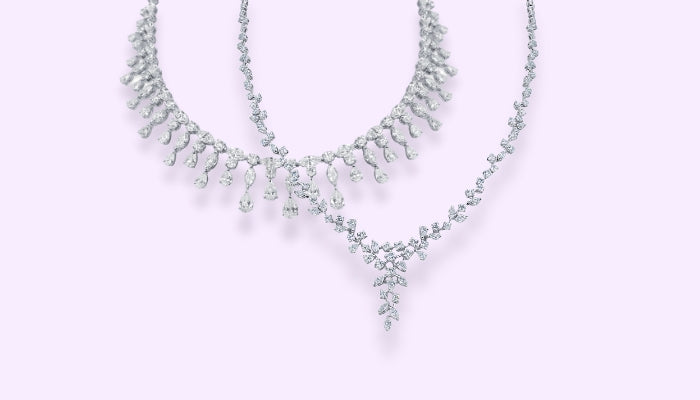 Platinum necklace with round, marquise and pear shaped colourless diamonds and a platinum necklace with marquise and round brilliant diamonds 